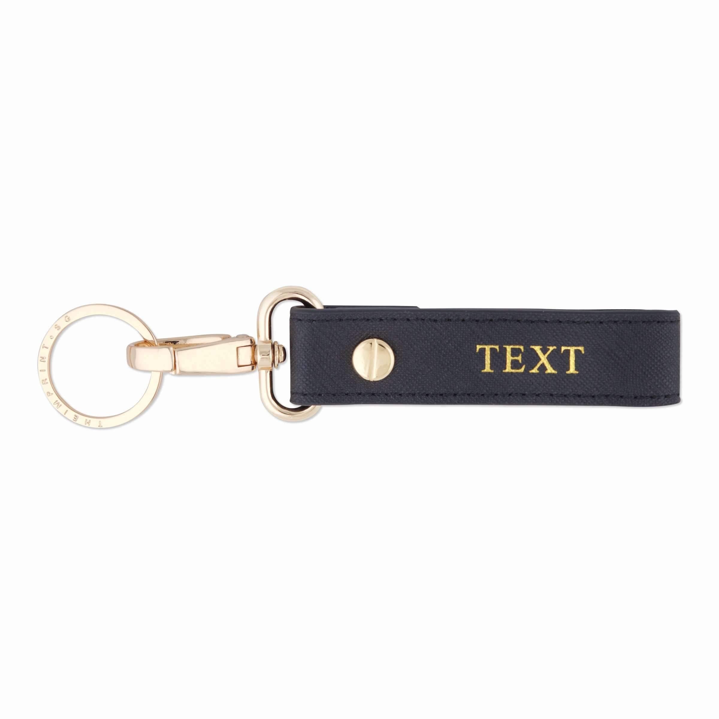 Saffiano keychain in black and with gold text